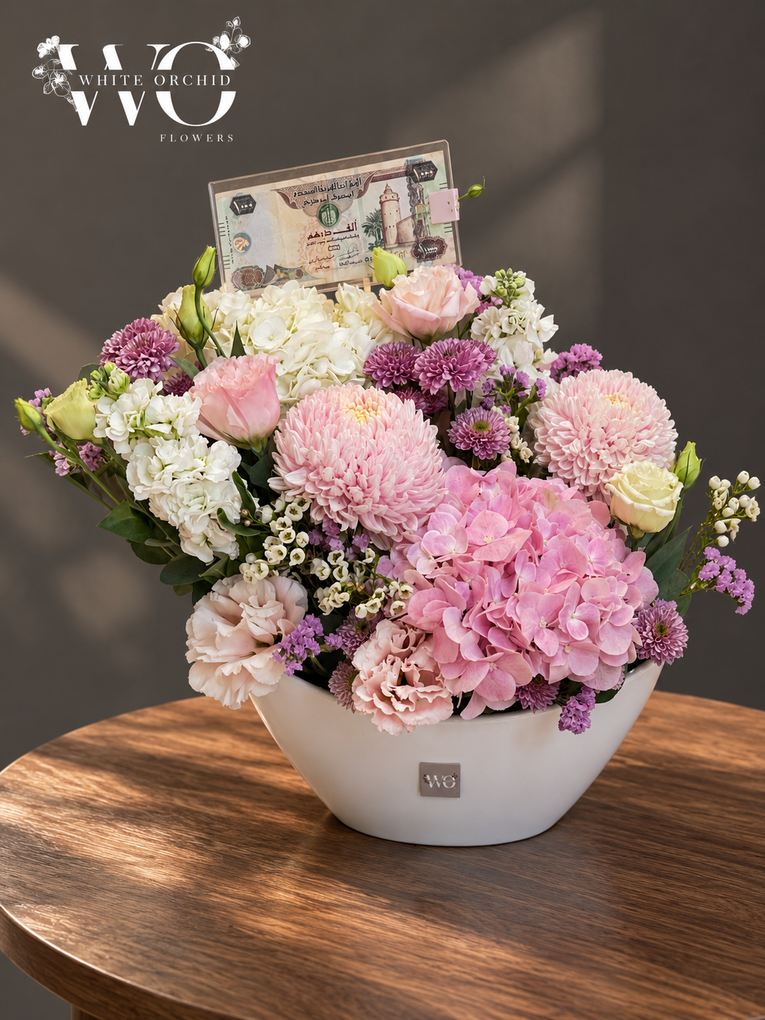 Pink and purple luxury floral arrangement with roses, hydrangeas and chrysanthemums in a white ceramic bowl by White Orchid Flowers