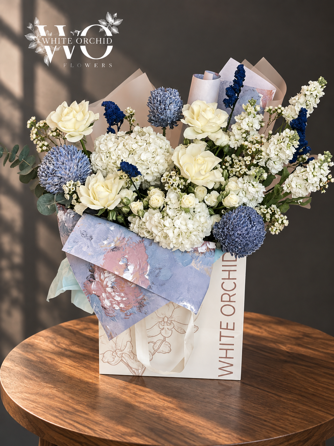 Blue and white luxury hand bouquet with roses, hydrangeas, chrysanthemums and delphiniums by White Orchid Flowers