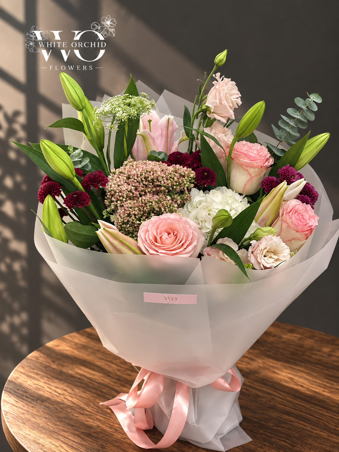 Pink and white hand bouquet with roses, lilies, hydrangeas and carnations by White Orchid Flowers