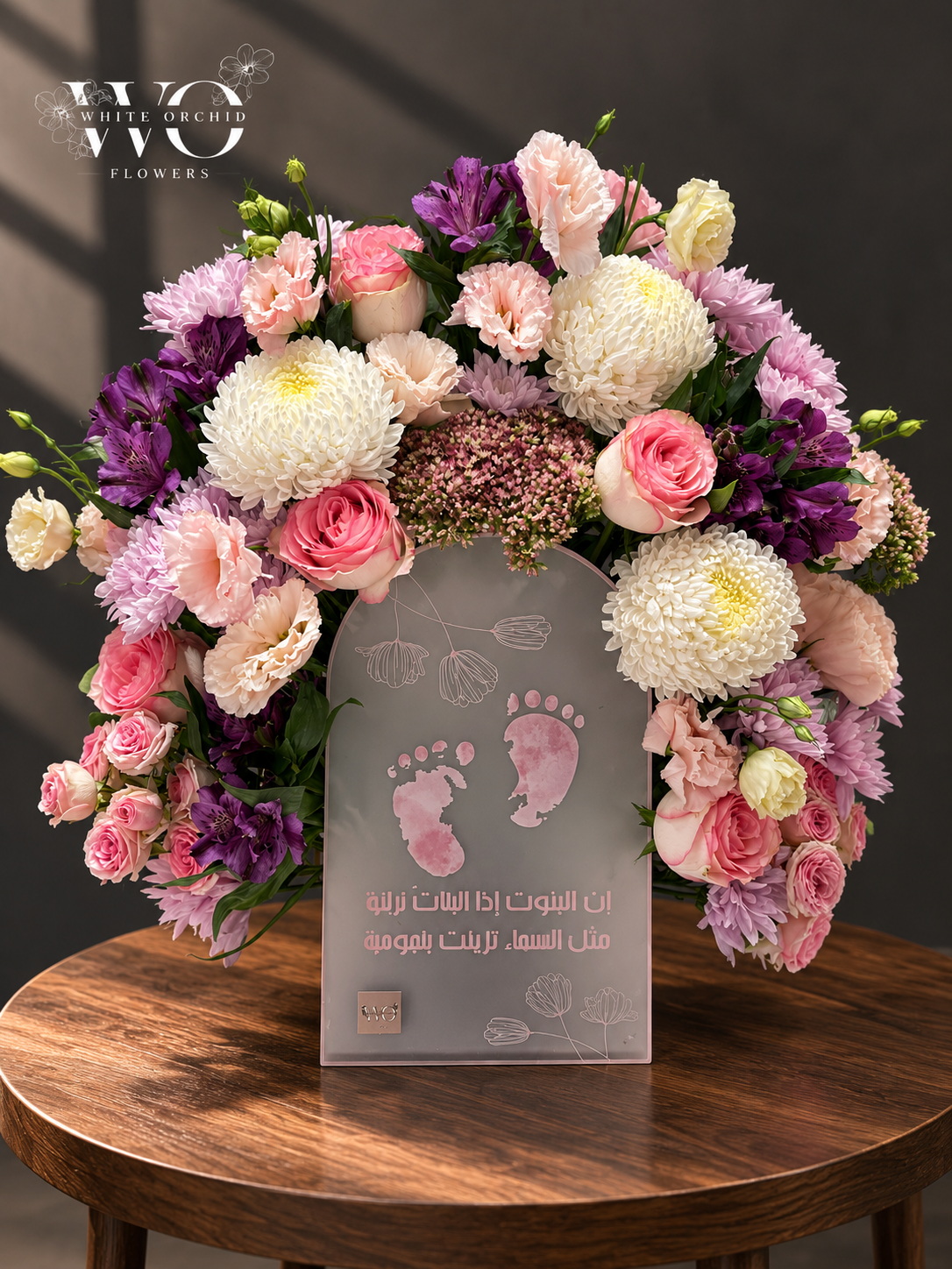 Baby girl floral arrangement with pink roses, carnations, chrysanthemums and a baby girl keepsake plaque by White Orchid Flowers