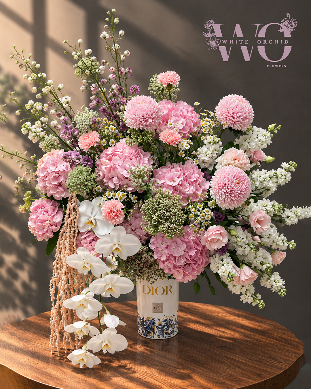 Luxury pink and white flower arrangement with hydrangeas, orchids and seasonal flowers in an elegant vase