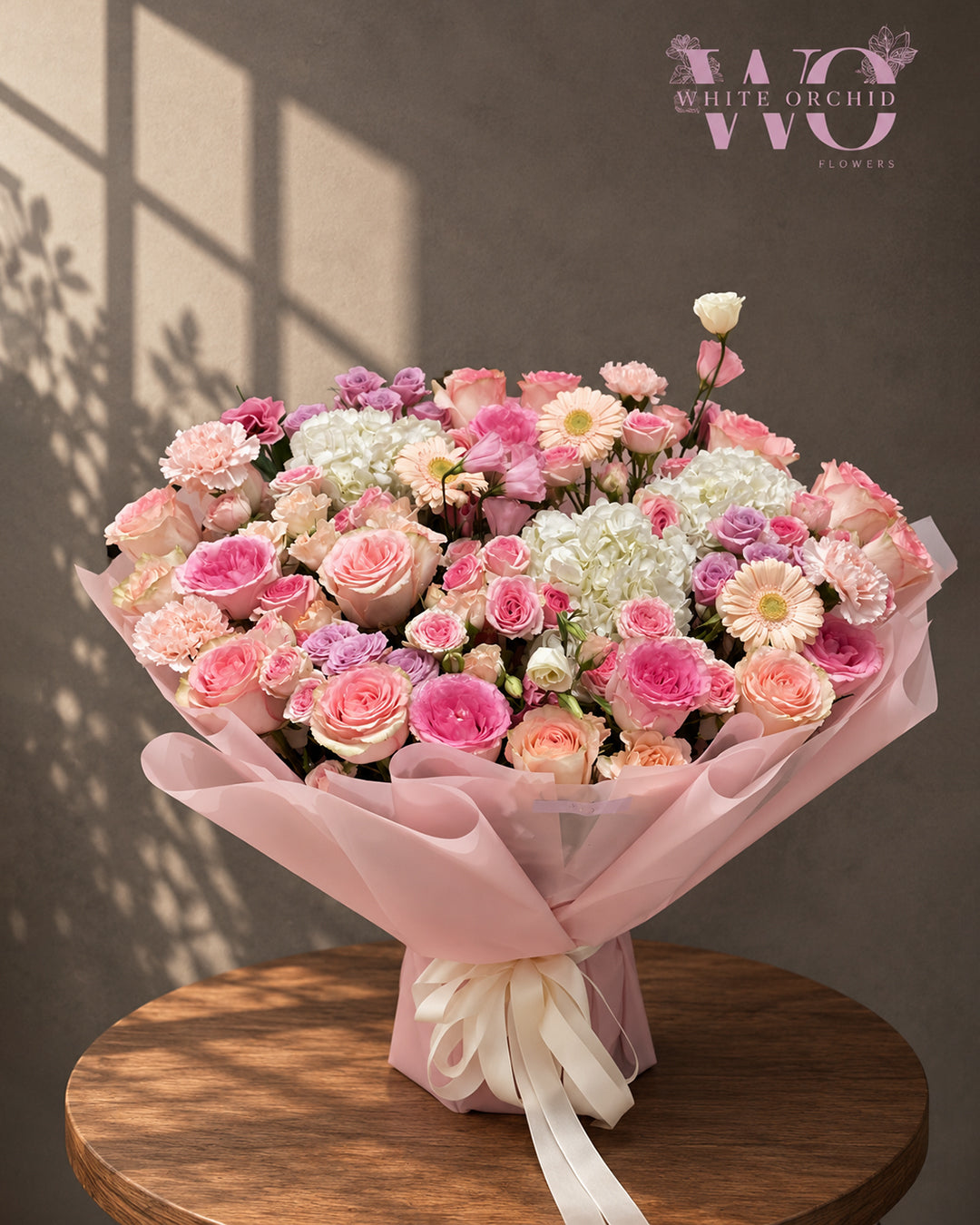 Pink and peach mixed flower bouquet with roses, hydrangeas and seasonal flowers by White Orchid Flowers