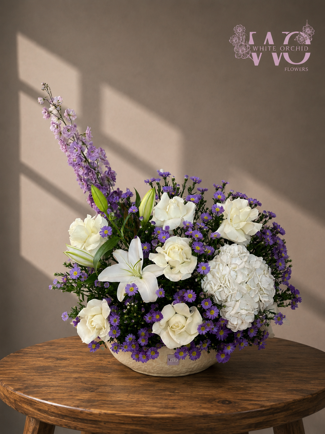 Purple and white luxury flower arrangement with white roses, lilies, hydrangeas and delicate purple flowers