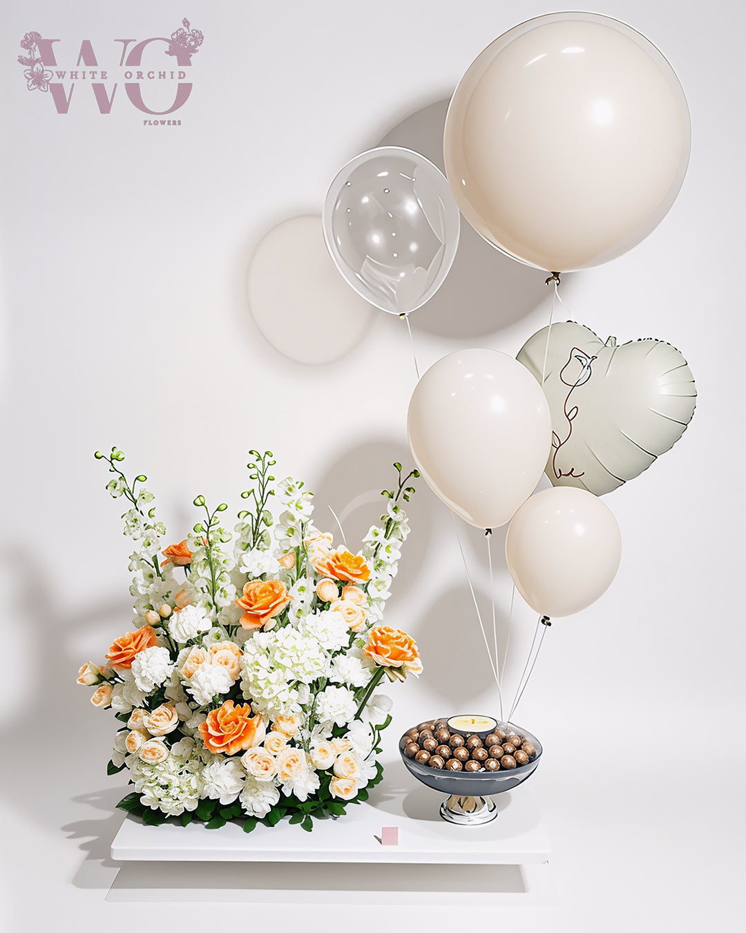Arrangement of fresh natural flowers with premium chocolate by White Orchid Flowers – luxury floral and chocolate gift with UAE delivery.