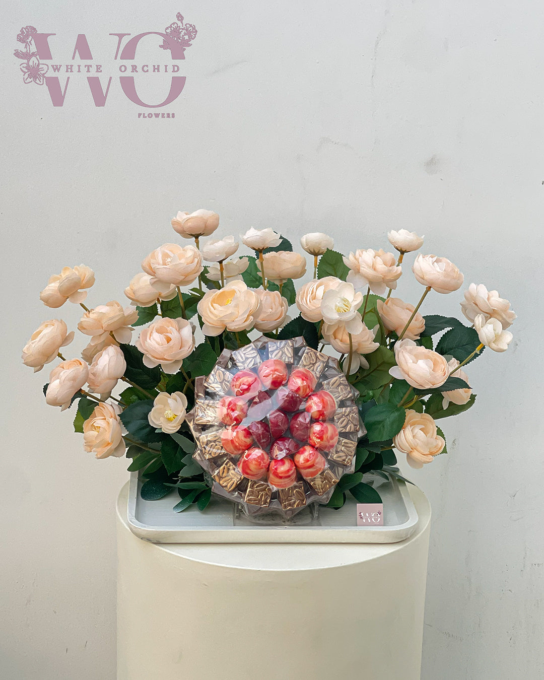 Arrangement of fresh natural flowers with premium chocolate by White Orchid Flowers – luxury floral and chocolate gift with UAE delivery