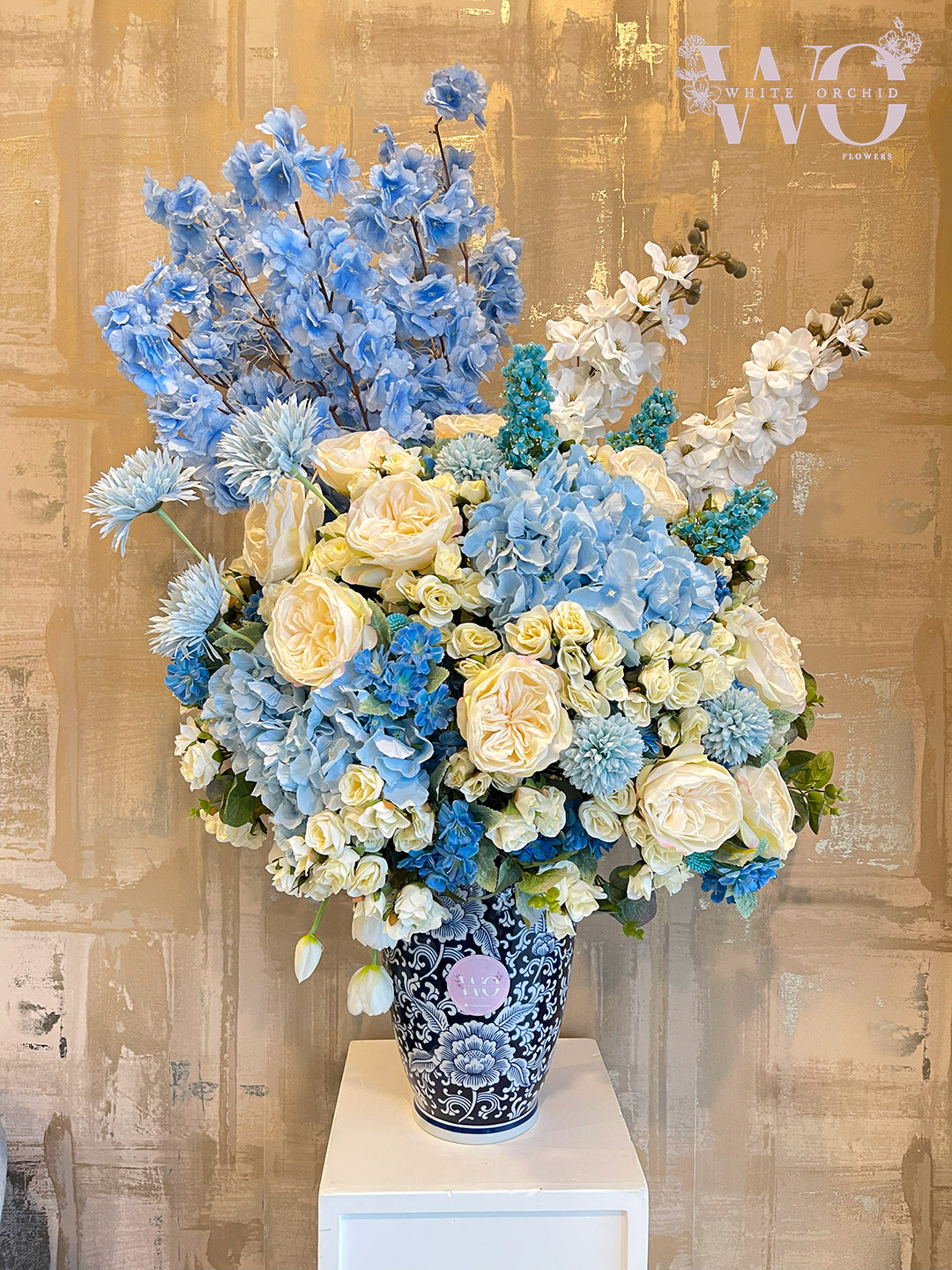 Artificial flower arrangement by White Orchid Flowers – realistic long-lasting decorative design with delivery across all UAE