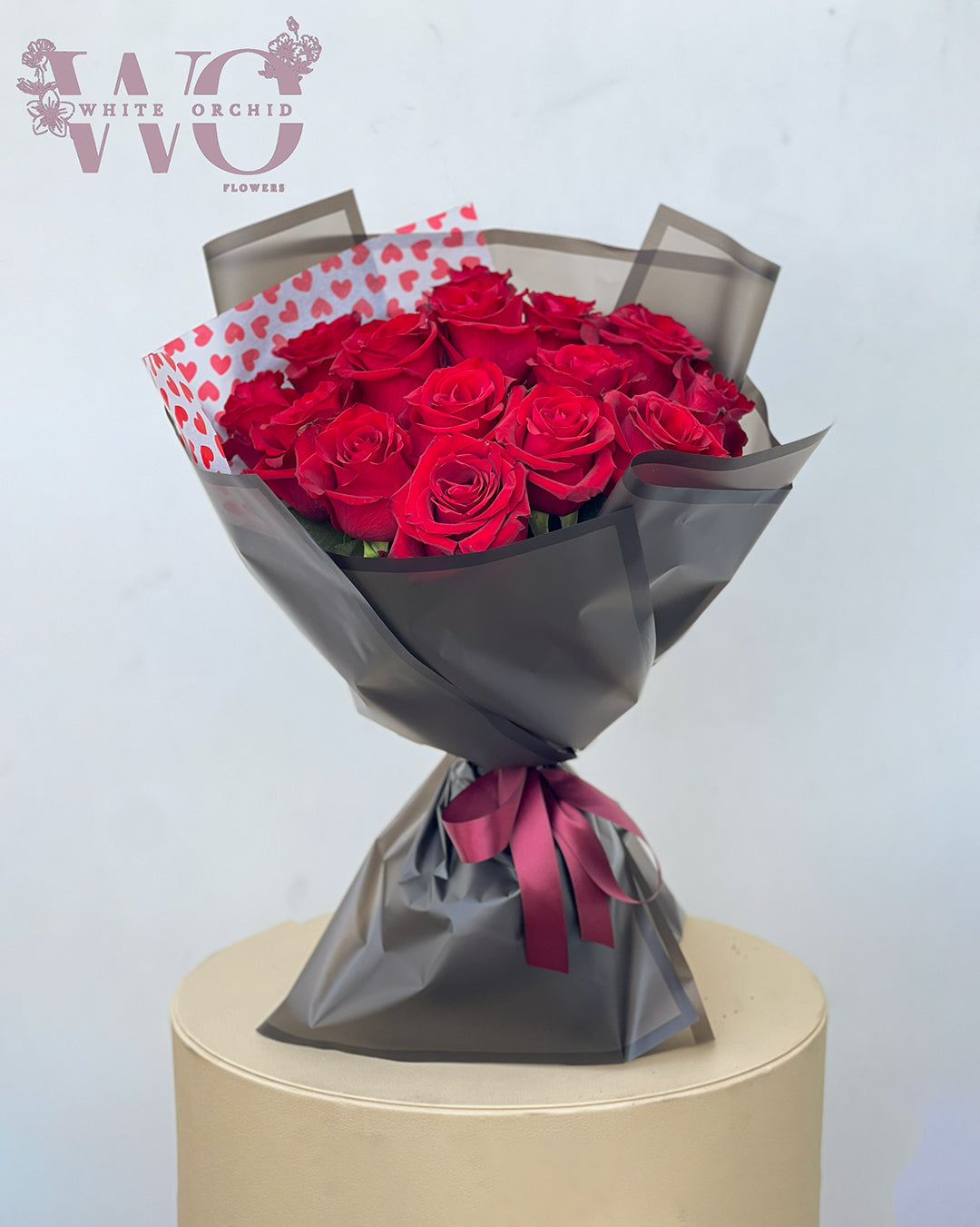 Valentine red rose hand bouquet made with natural fresh roses by White Orchid Flowers – classic romantic bouquet with delivery across all UAE.