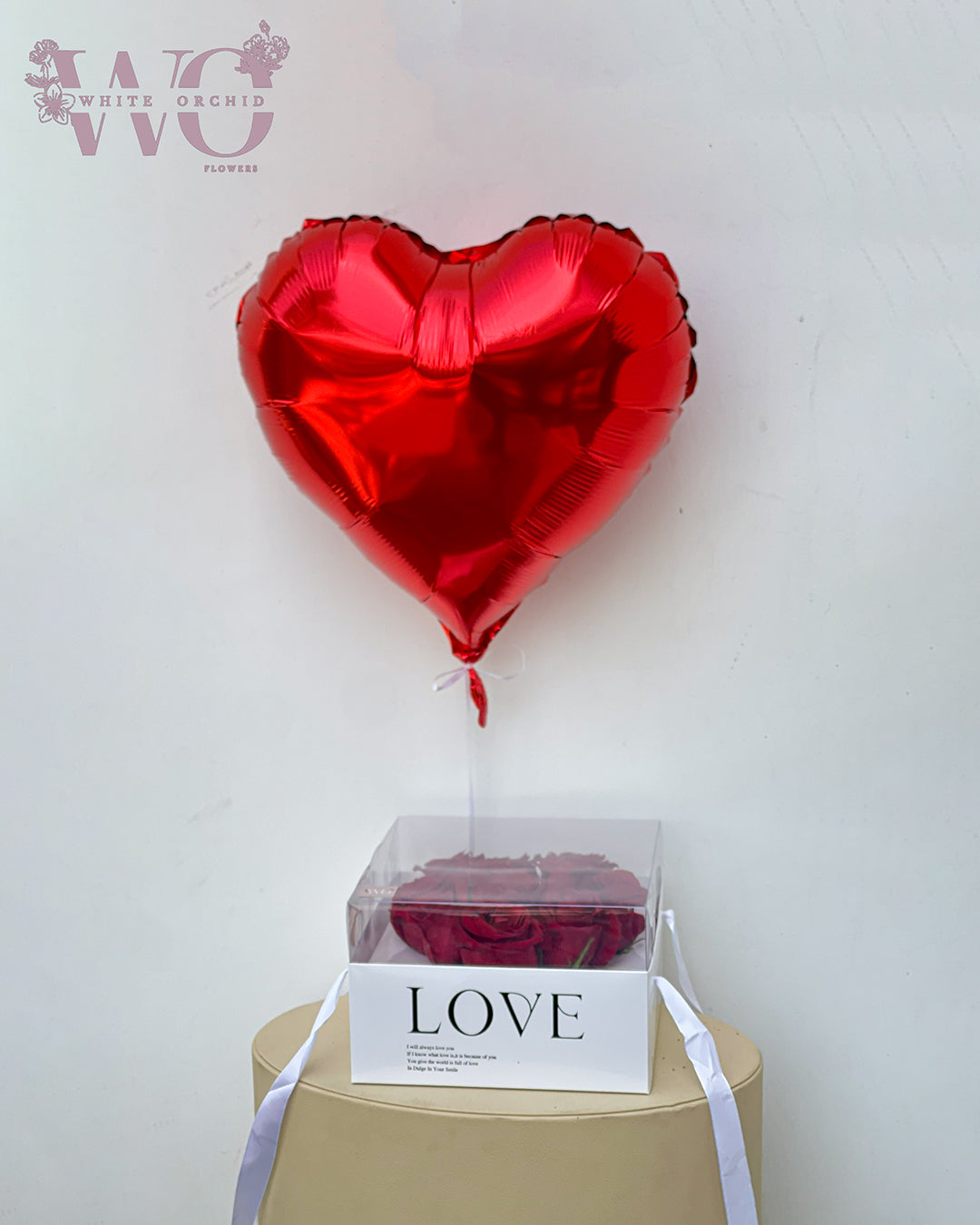 Valentine red rose box with heart-shaped helium balloon by White Orchid Flowers – romantic flower box gift with delivery across all UAE.