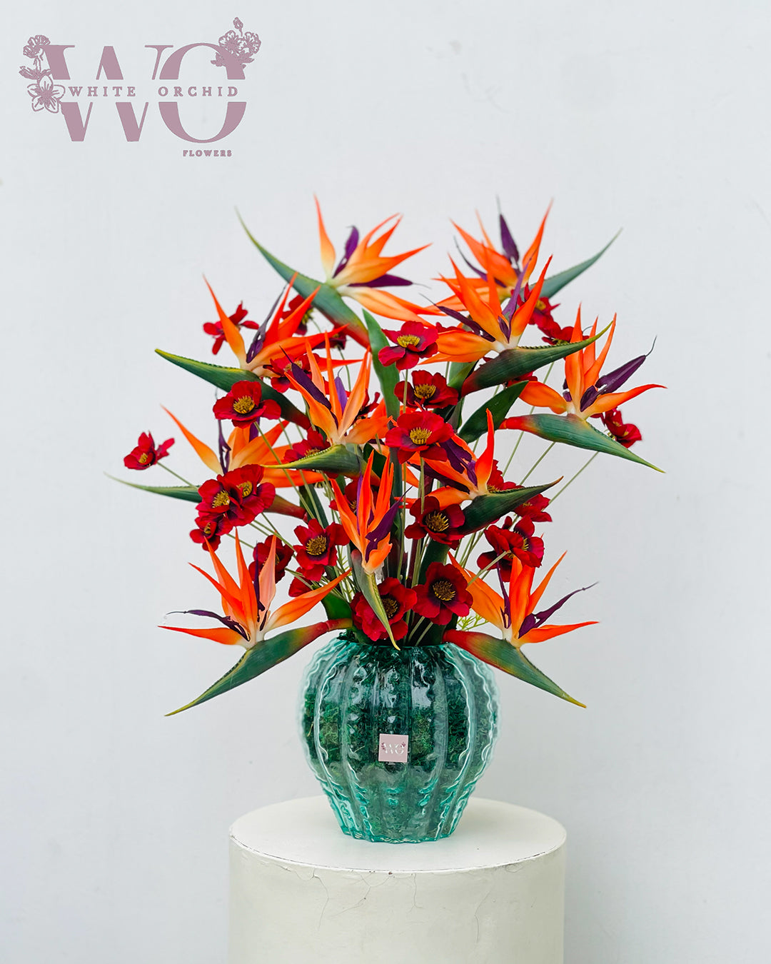 Bird of paradise flower arrangement with fresh exotic flowers in decorative vase by White Orchid Flowers UAE.
