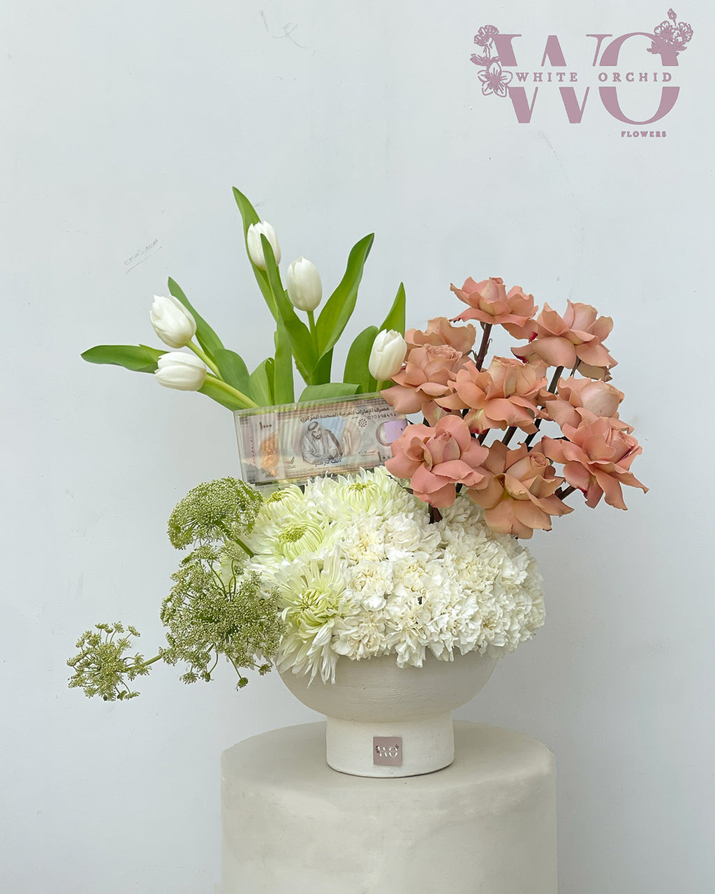 Elegant mixed floral arrangement with white tulips and peach roses in a modern vase by White Orchid Flowers UAE.