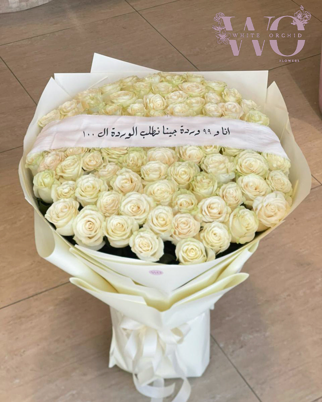 Luxury bouquet of 100 fresh white roses arranged in elegant wrapping by White Orchid Flowers UAE
