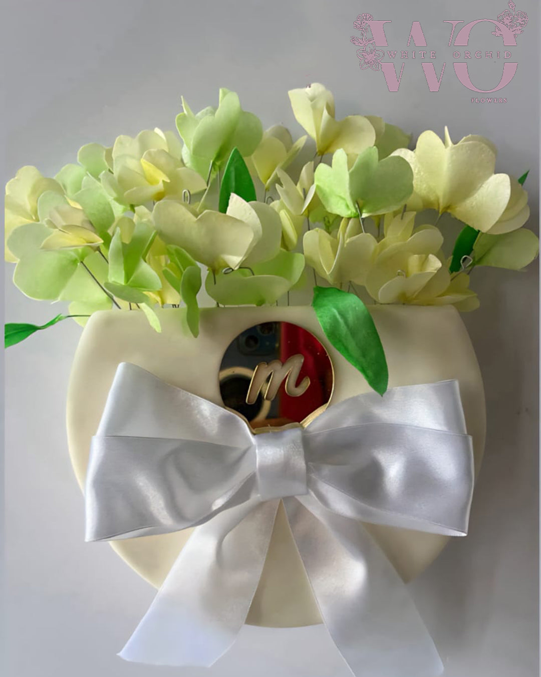 Mother’s Day luxury cake with floral design and ribbon decoration by White Orchid Flowers UAE.