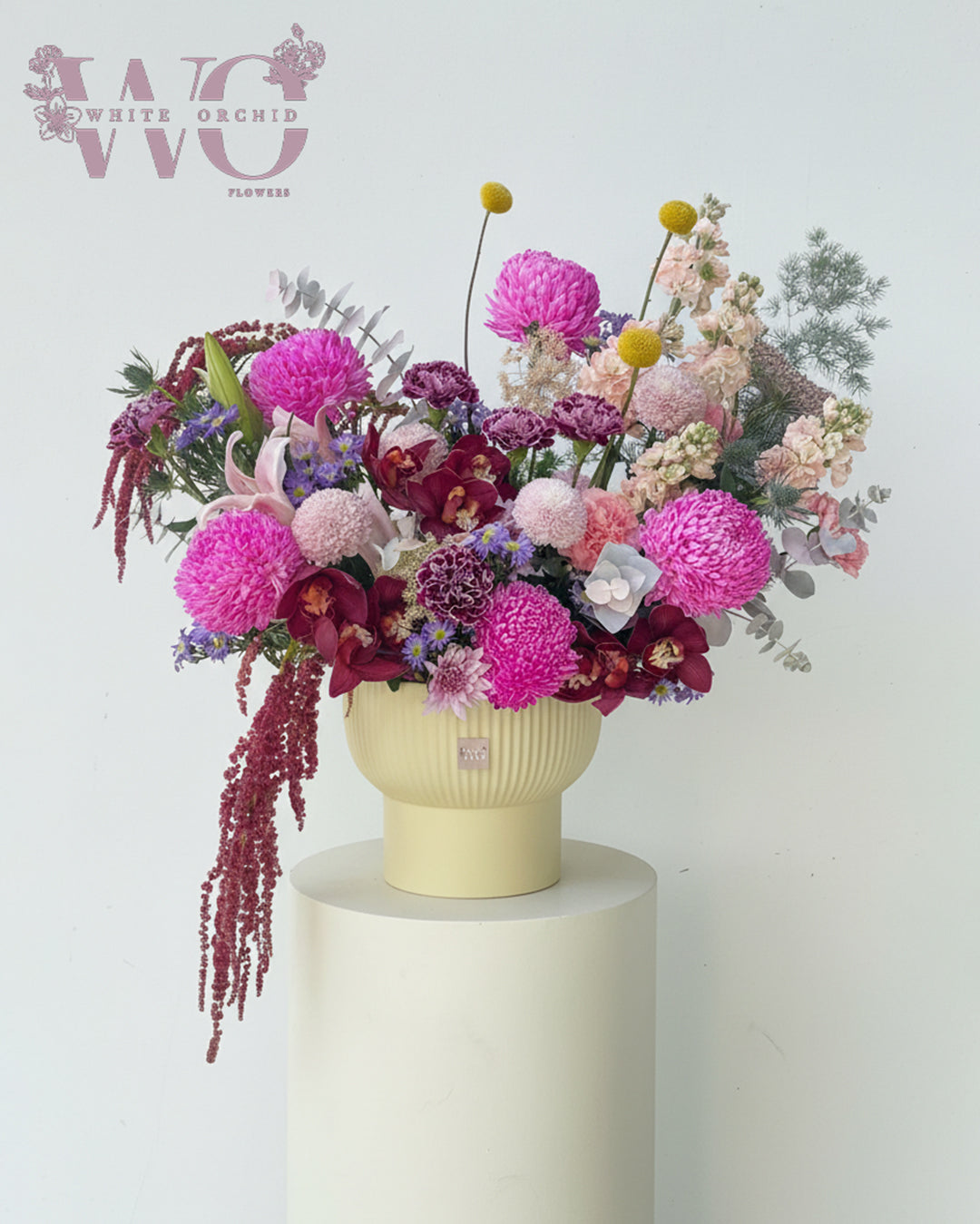 Luxury mixed flower arrangement with orchids and seasonal flowers by White Orchid Flowers UAE.