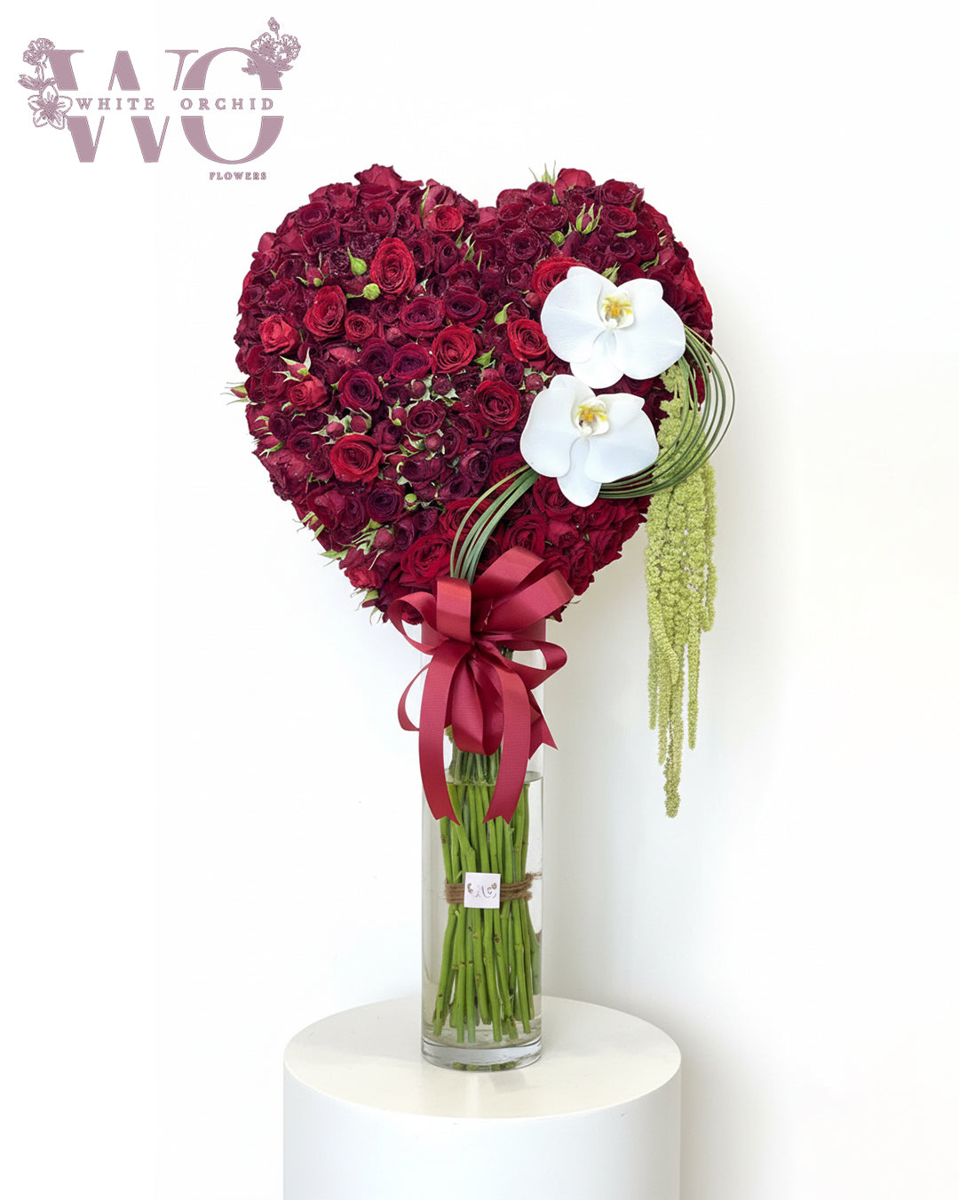Valentine red heart-shaped flower bouquet made with natural fresh flowers by White Orchid Flowers – romantic floral gift with delivery across all UAE.