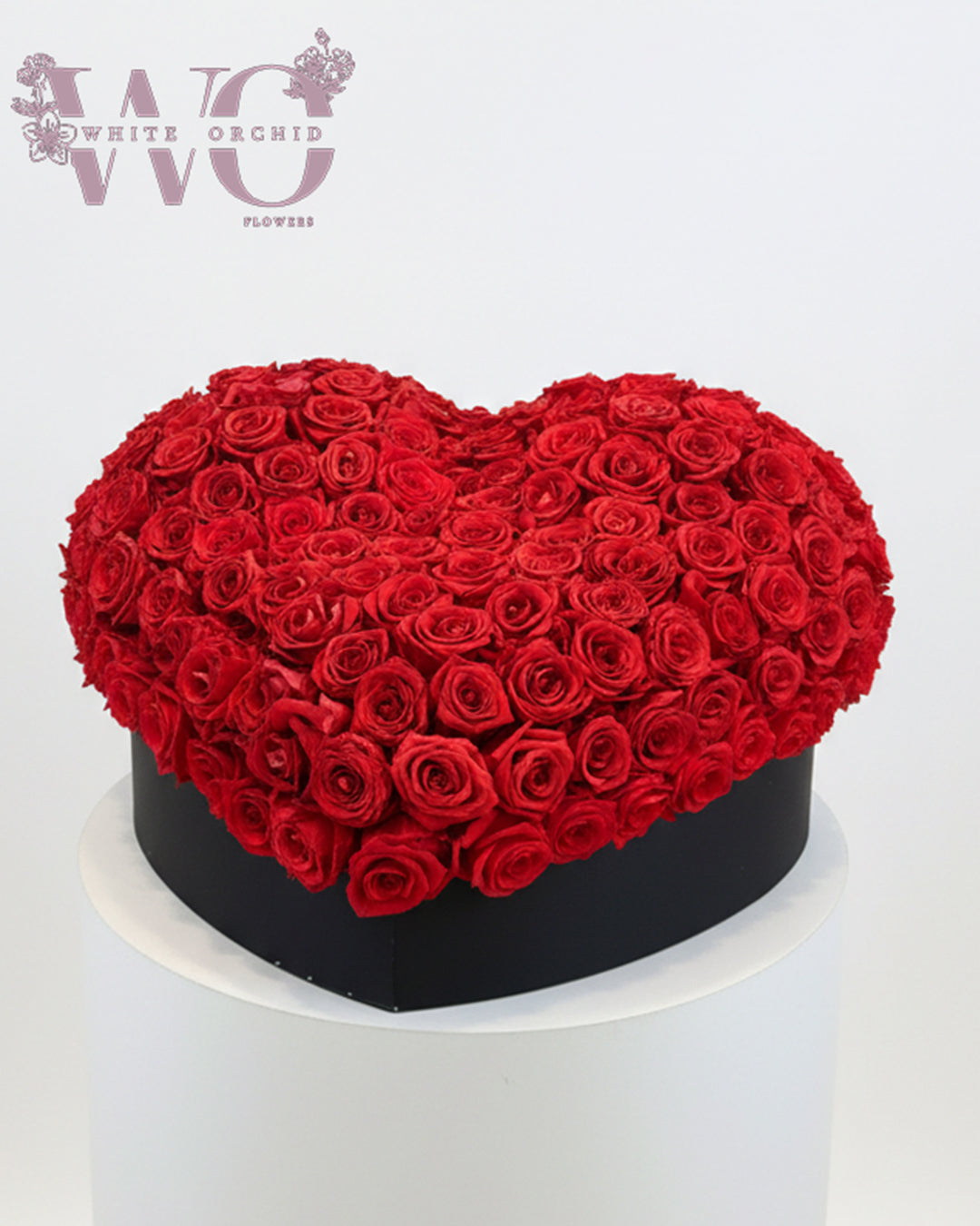 Valentine red rose heart arrangement made with natural fresh roses by White Orchid Flowers with delivery across all UAE.
