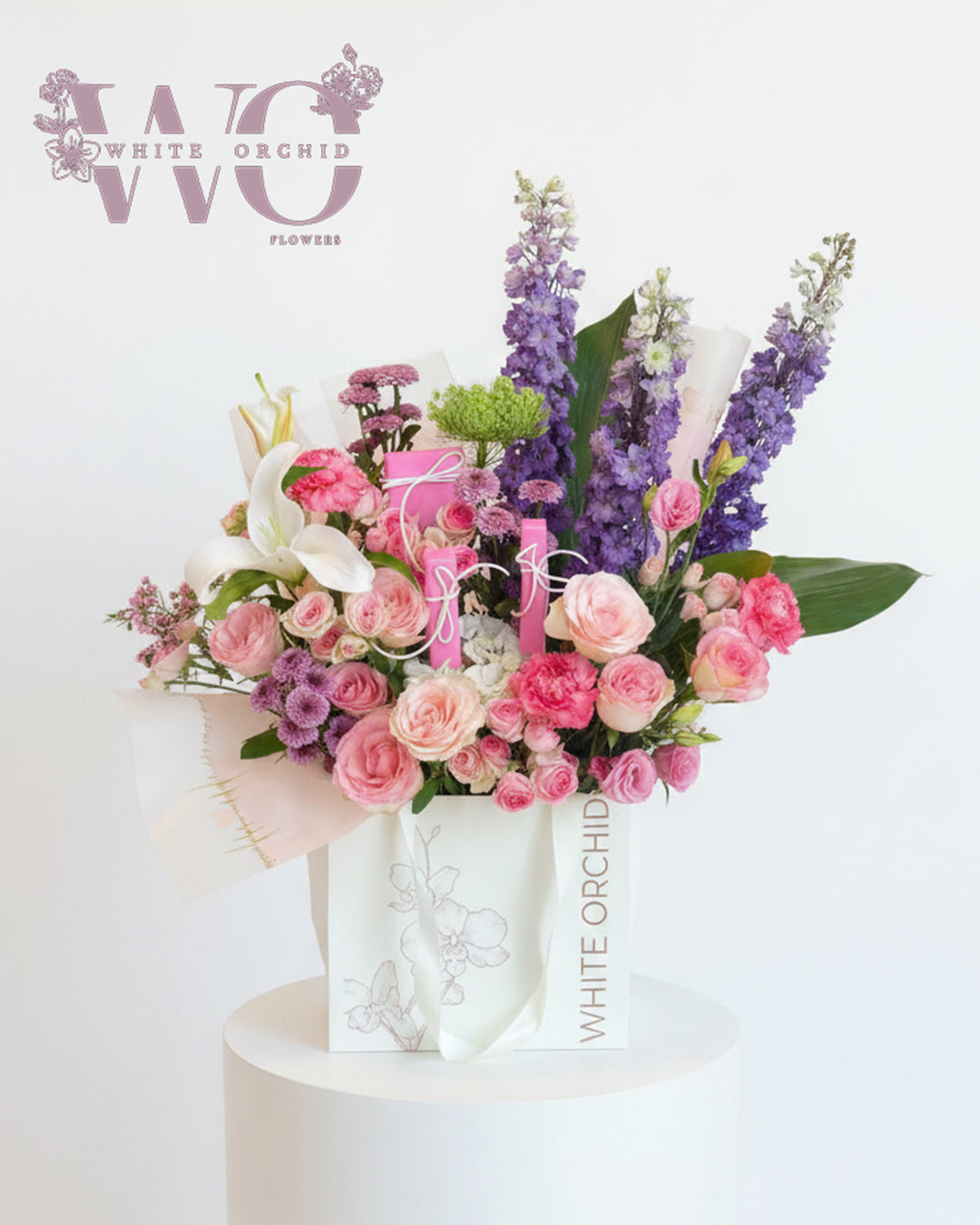 Mix color fresh flower bouquet with elegant wrapping by White Orchid.