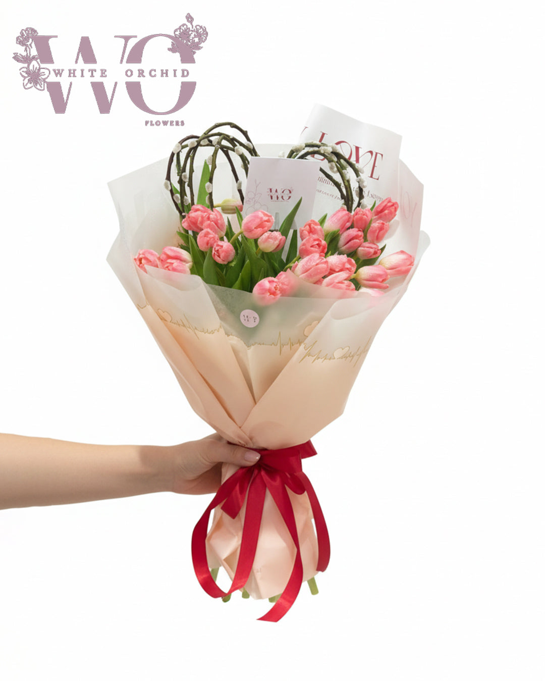 Pink tulip hand bouquet with elegant wrapping by White Orchid Flowers UAE.